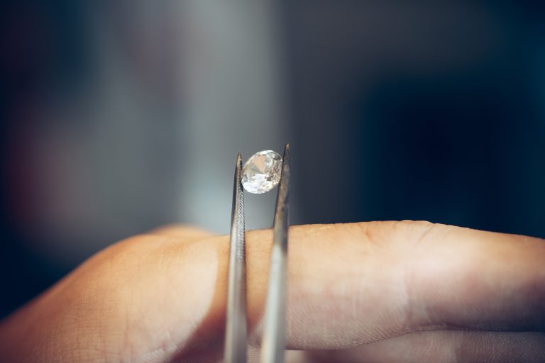 Different goldsmiths tools on the jewelry workplace. Jeweler at work in jewelry. Desktop for craft jewelry making with professional tools. Close up view of tools.